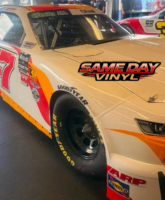 Race car staged in a Daytona Beach garage ready for custom racing graphics and vinyl application