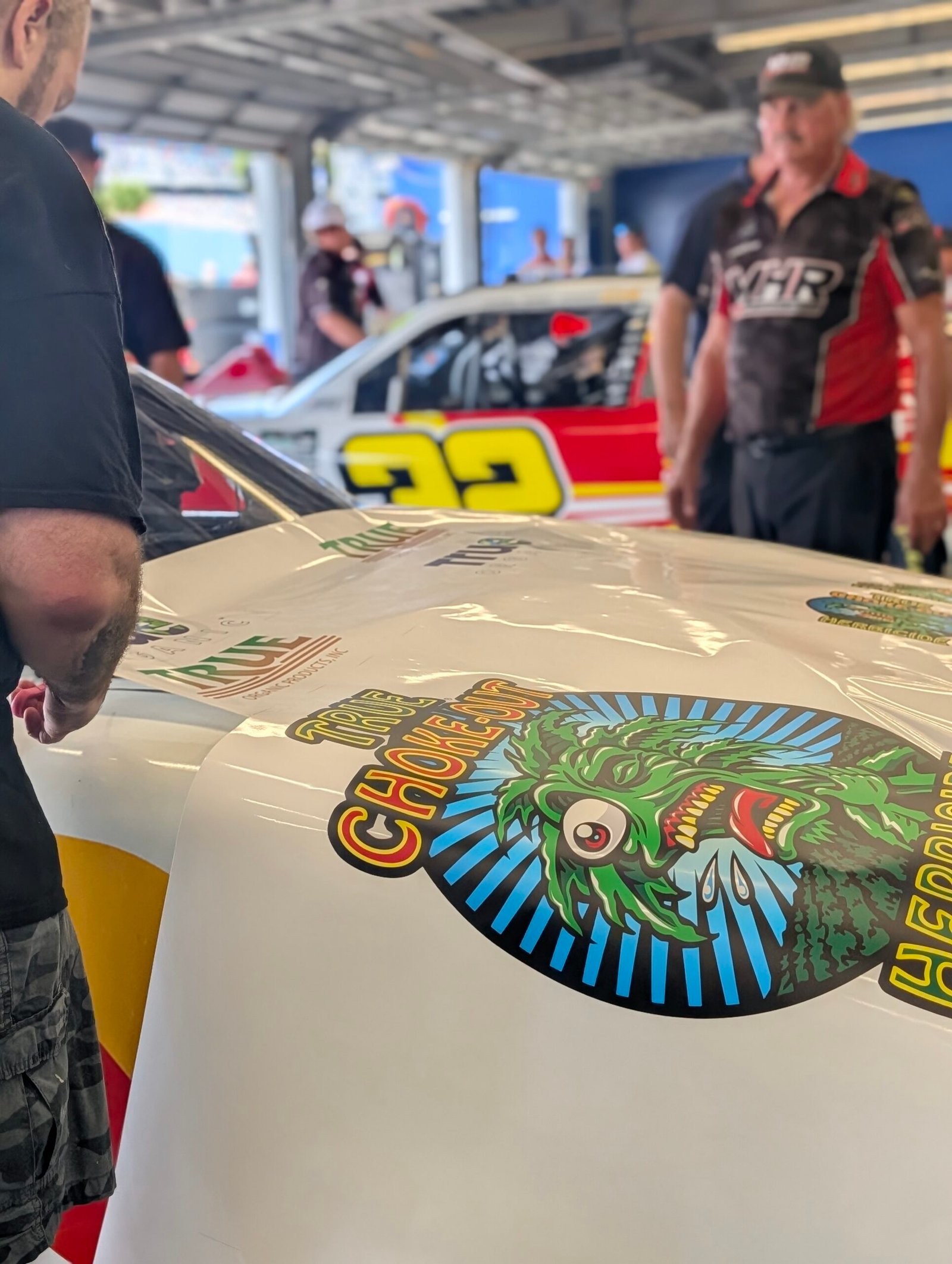 Damaged race car quarter panel in need of a replacement decal - fast race car decals Daytona Beach graphics repair