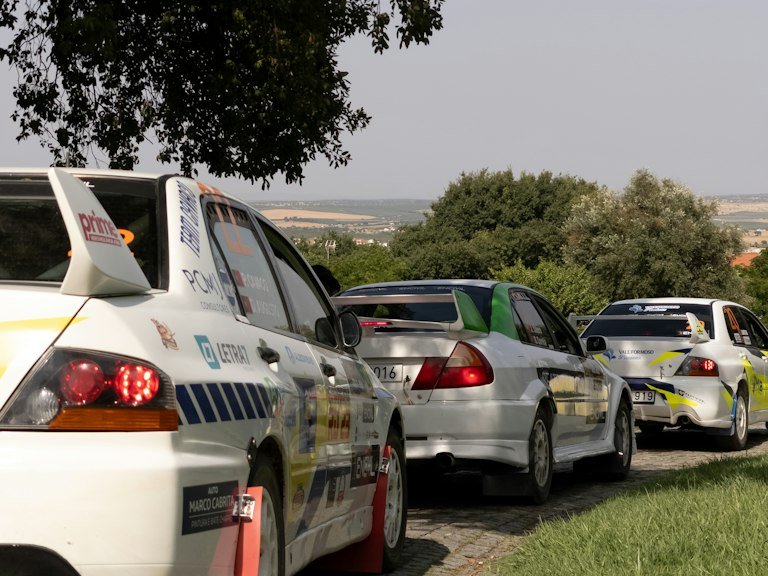 Windshield banner vinyl decal on a rally car lined up for race day