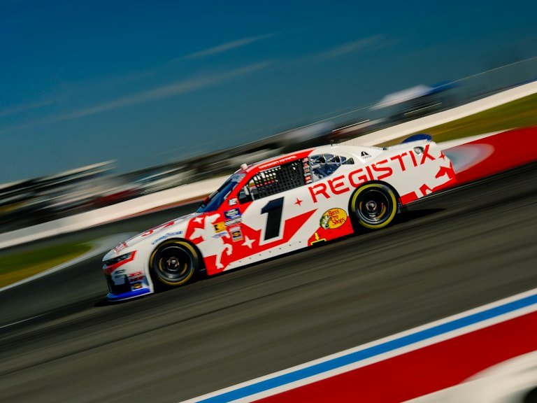 Race car vinyl graphics with motion blur speeding down straightaway
